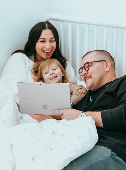 Family at home using a laptop and feeling secure